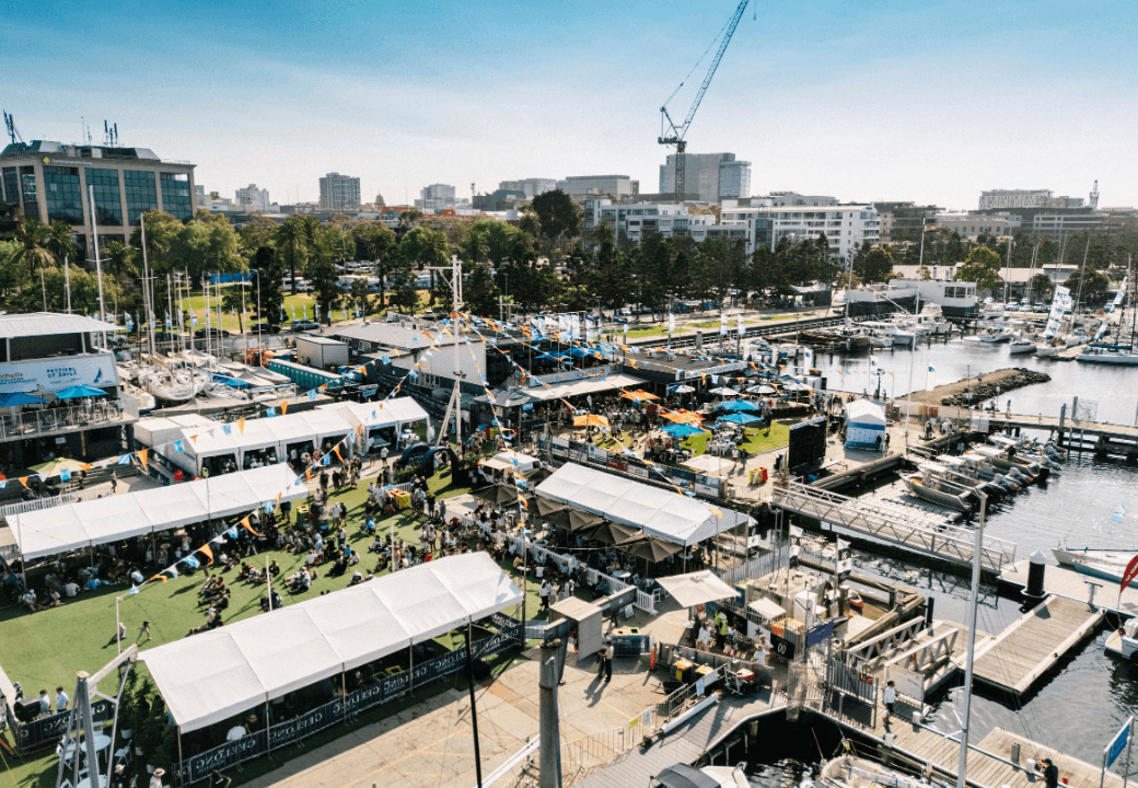 An aerial photo of the Festival of Sails looking at the buildings, bunting, and summer festival from above.