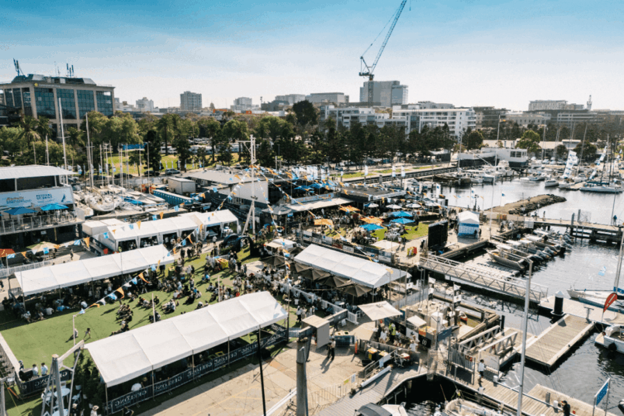 An aerial photo of the Festival of Sails looking at the buildings, bunting, and summer festival from above.