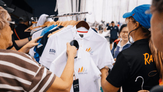 A merchandise rack with Festival of Sails merchandise, shirts and apparel on it. Customised for each year and available for sale in 2027 for competitors.