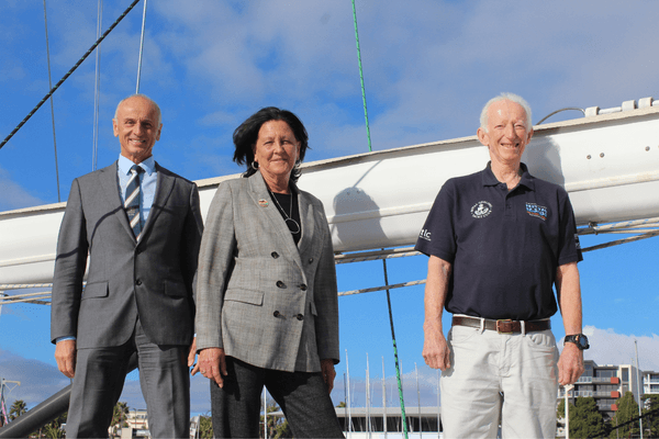 Geelong Mayor Stretch Kontelj, Member for Geelong Christine Couzens and Royal Geelong Yacht Club Vice Commodore Phil Francis stand on a boat to share their commitment to Festival of Sails 2027.